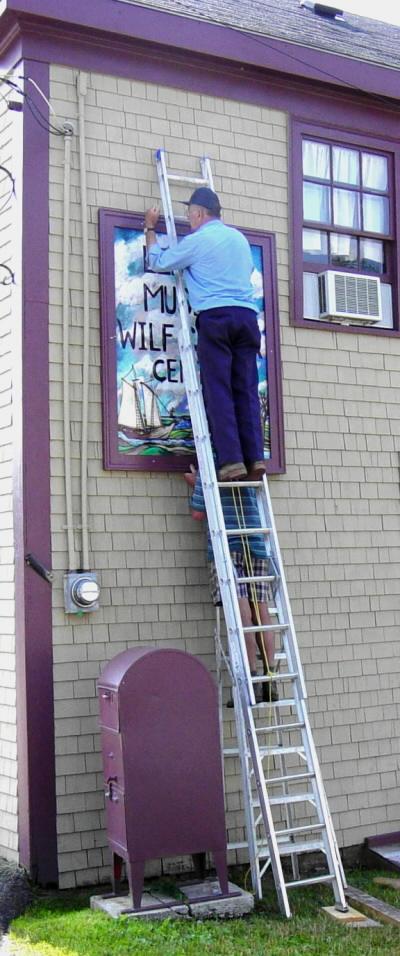 Installing new sign on the Canning Heritage Centre